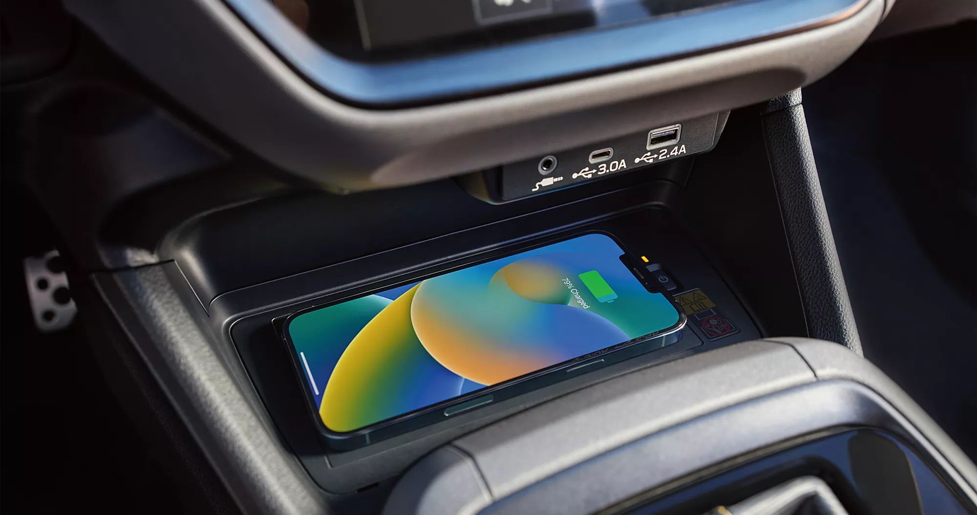 Center console area showing phone storage and charging area